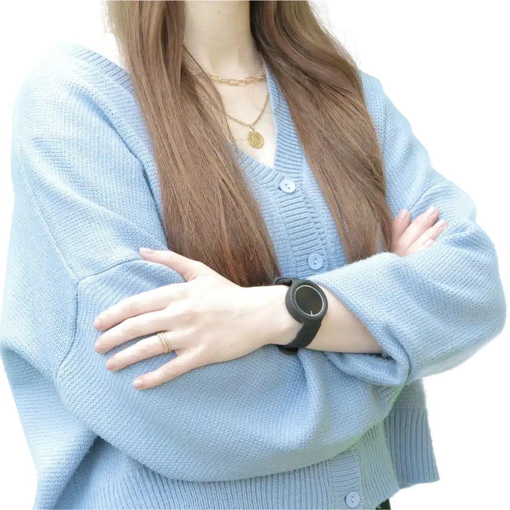 woman with long hair and blue cardigan wearing the wristband with button